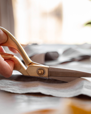 person-cutting-fabric-sewing-2